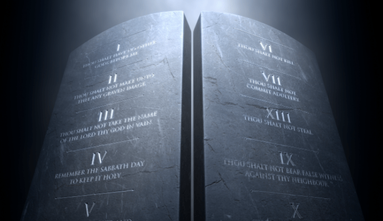 the Ten Commandments engraved on dark stone tablets