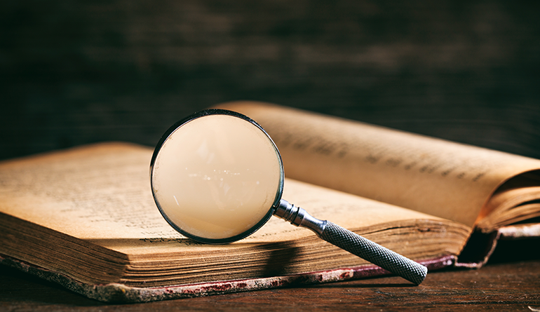 magnifying glass on open book