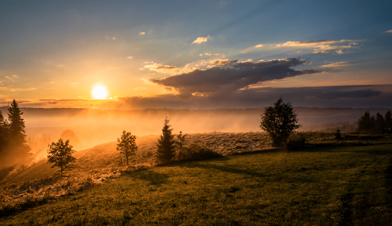 sunset over a hilly field